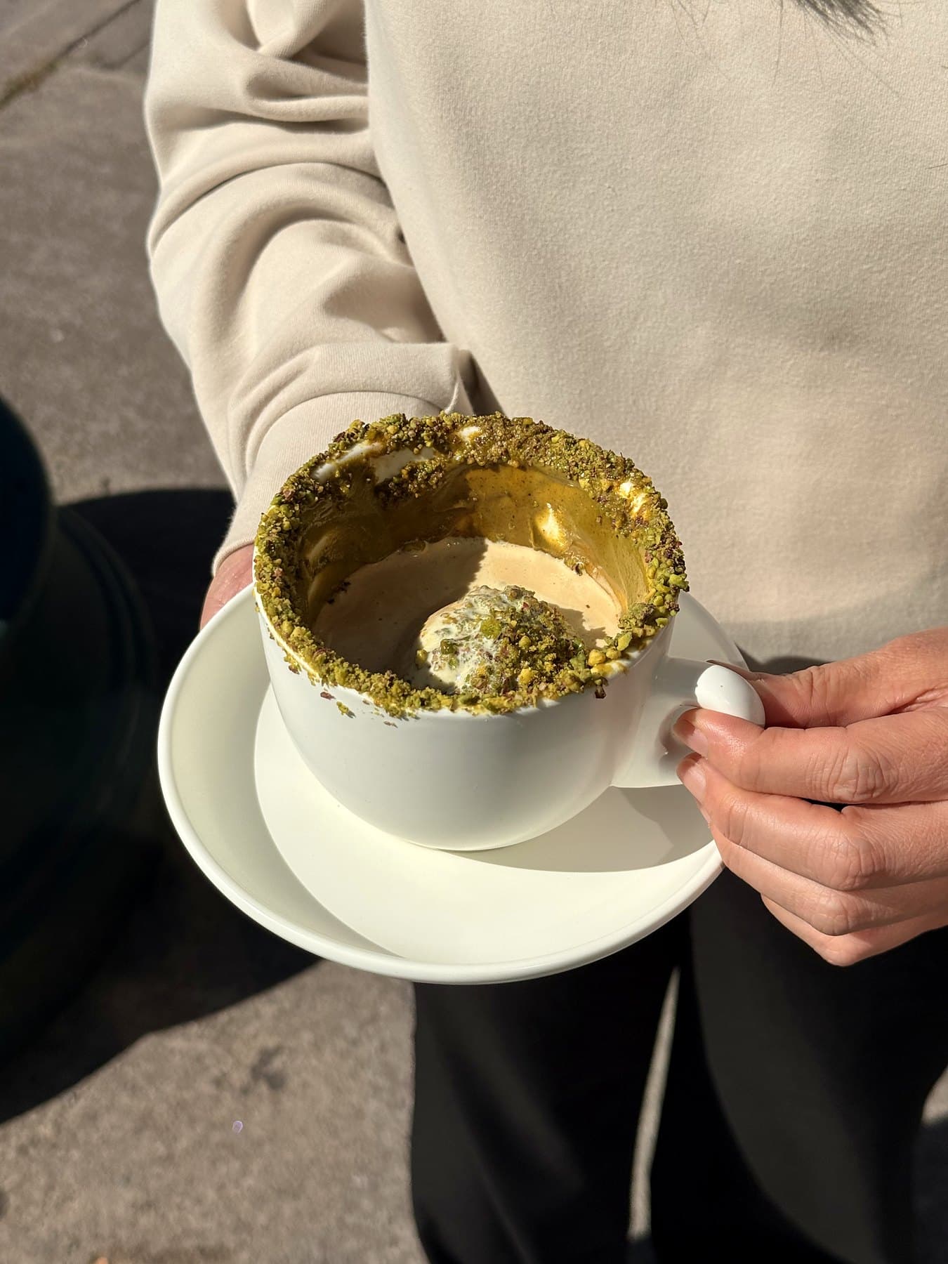 Pistachio affogato held outside on Spadina Avenue
