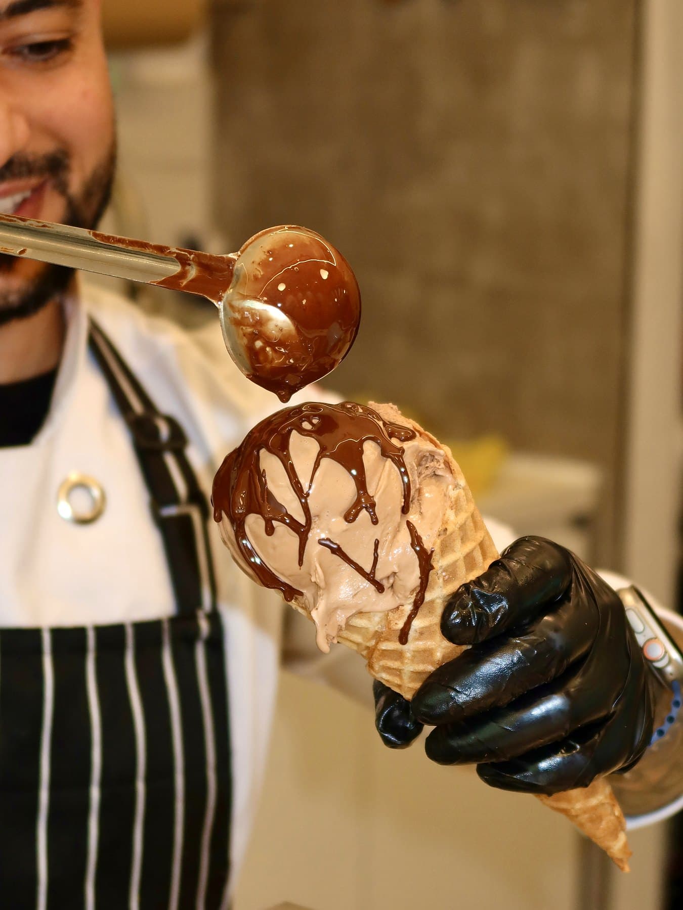 Can drizzling chocolate over a scoop of ice cream in a waffle cone