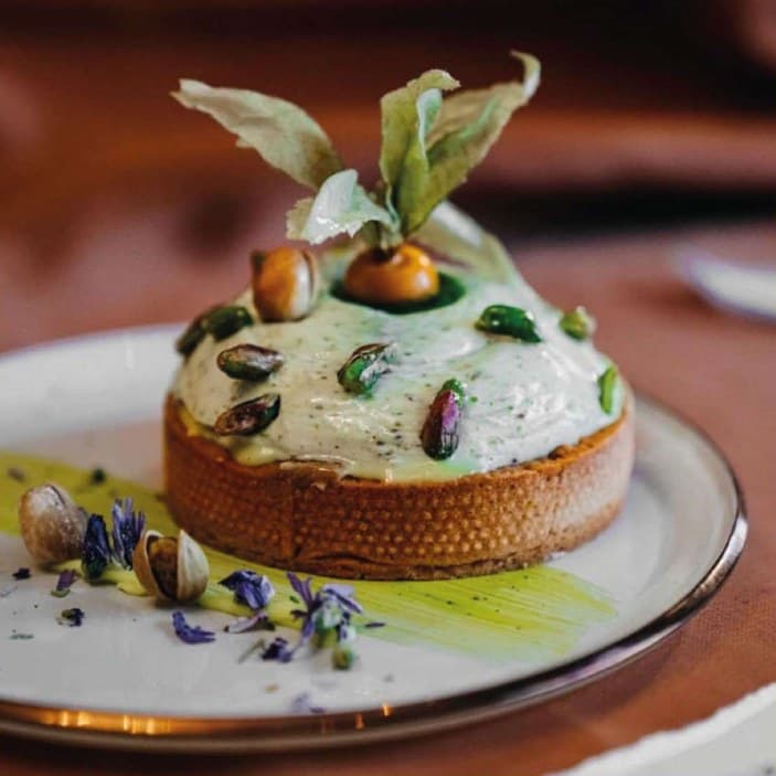 Pistachio cream tart with physalis garnish